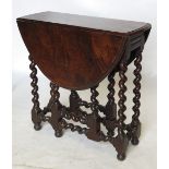 An 18th century style oak gate leg table, raised on spirally turned legs, with gate leg action,