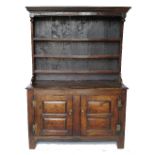 An Antique oak dresser, with close boarded Delft rack over,