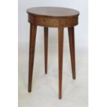 An oval mahogany work table, the rising lid revealing shallow interior,