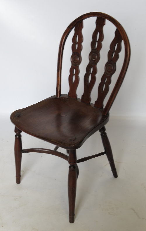 An early 19th century Windsor chair, with three pierced splats and central roundels,