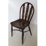 An early 19th century Windsor chair, with three pierced splats and central roundels,