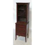 A 19th century mahogany cupboard, the glazed door opening to reveal shelves,