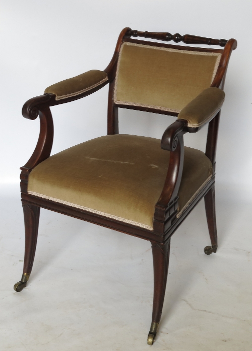 A mahogany armchair, with open scroll part padded arms, padded back and seat,