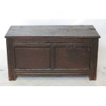 An 18th century oak coffer, with plain rising lid above twin panelled front,