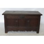 A 19th century oak coffer, with plain rising lid and three plain panels to the front,