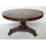 An early 19th century circular rosewood breakfast table, raised on part carved column,