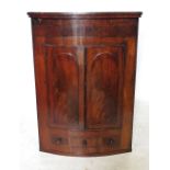 A 19th century mahogany bow front corner cupboard,