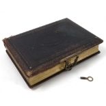 A Victorian leather bound musical photograph album, the pages printed with landscapes and flowers,
