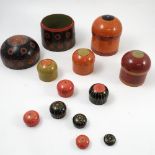 A set of twelve wooden stacking boxes, of cylindrical form with domed lids,