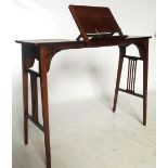 An Edwardian mahogany music table, having ratcheted central section with rising music stand,