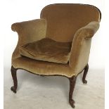A late 19th century mahogany framed armchair, with roll arms and gadrooned carved back,