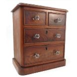 A miniature mahogany chest, of two short drawers over two long drawers, with glass handles,