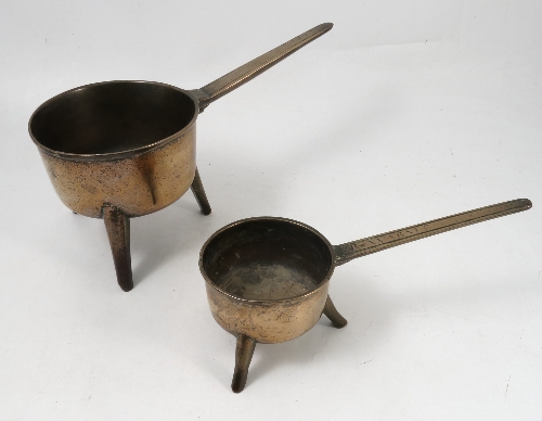 A bronze skillet, raised on three legs, diameter of bowl 7ins, together with a smaller example,