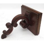 A mahogany wall shelf, the square top with bead edge, on a carved scroll support,