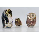 Three Royal Crown Derby paperweights, two modelled as owls, the other as a penguin,