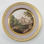 A French plate, decorated with buildings in a wooded landscape,
