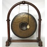 A late 19th century reception dinner gong, within a horseshoe shaped frame,