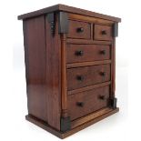 An early 19th century mahogany miniature chest, of two short drawers over three long drawers,