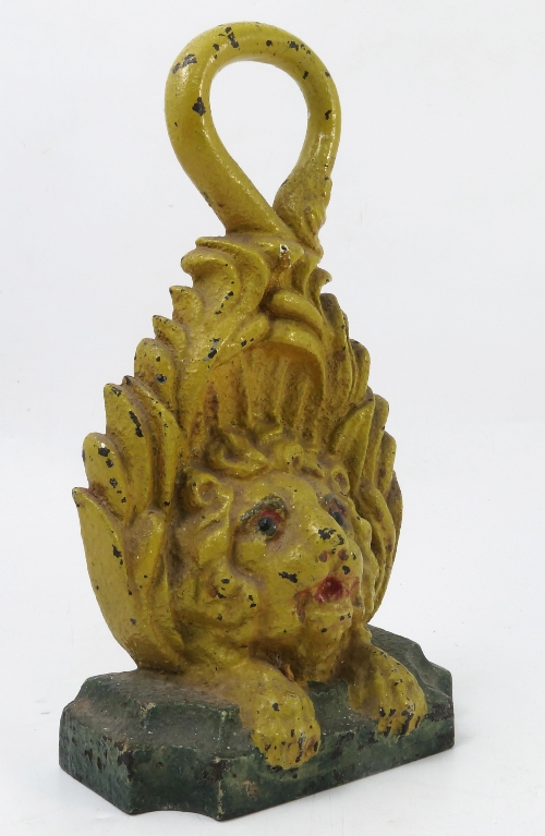 A painted cast iron door stop, formed as a lion, with its tails forming the ring handle,