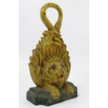 A painted cast iron door stop, formed as a lion, with its tails forming the ring handle,
