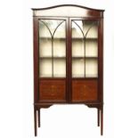 An Edwardian mahogany display cabinet, the arched frieze with inlaid decoration,