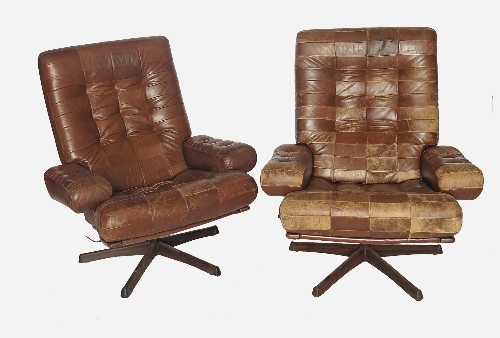 A pair of Mobel leather armchairs, with swivel action,