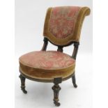 A 19th century ebonised nursing chair,