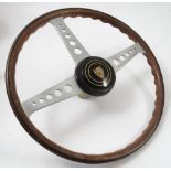 A wooden Jaguar steering wheel, stamped Formula De-Luxe,