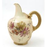 A Royal Worcester blush ivory flat back jug, decorated with printed painted floral sprays,