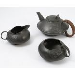 A Liberty Tudric pewter three piece tea set, designed by Archibald Knox, numbered 0231,