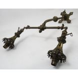 A pair of brass twin light gas light fittings, of T form, with regulator valves and pierced shades,