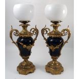 A pair of ormolu mounted porcelain vases, having a deep blue ground with gilt swags,