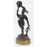 A 19th century bronzed candlestick, formed as a soldier in armour holding the sconce,