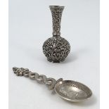 A 19th century Indian silver vase, of baluster form, decorated with scrolls and leaves, height 3.