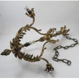 A brass hanging light fitting, decorated with leaves and scrolls, with six light,