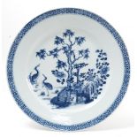 A Qianlong dish, decorated in blue and white with a tree, flowers and storks,