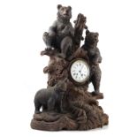 A large Black Forest bear carved wooden clock, the Lenzkirch striking movement stamped 451874,