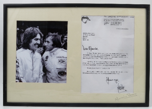 A framed black and white photograph, of Sir Jackie Stewart and George Harrison,