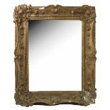 A gilt framed wall mirror, of rectangular form, the frame decorated with shells,