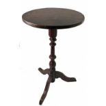 A primitive circular occasional table, with turned column, raised on a shallow tripod base,