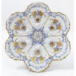 A Meissen porcelain plate, the body heavily embossed with flowers, leaves and scrolls,