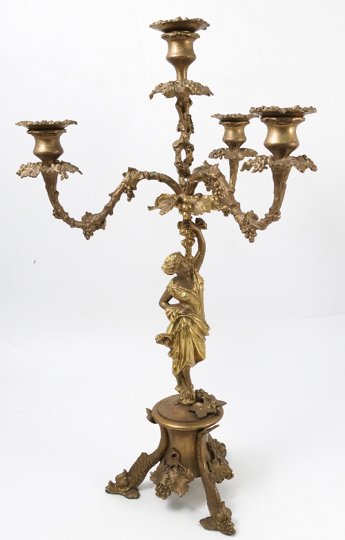 A gilt metal candelabrum, the four lights with vine branches supported by a female figure column,