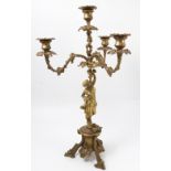 A gilt metal candelabrum, the four lights with vine branches supported by a female figure column,