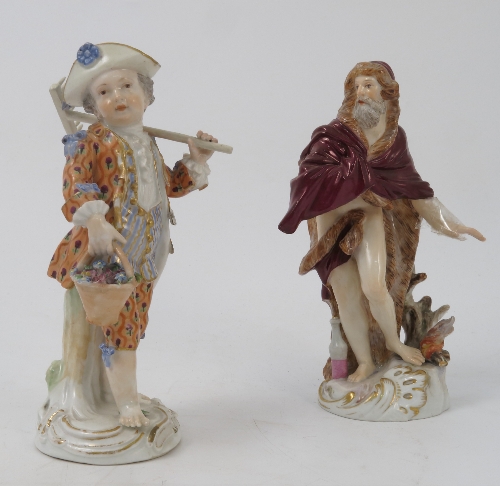 A Meissen figure, emblematic of Winter, of a bearded man wearing a fur lined clock by a fire,