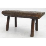 A primitive oak rectangular stool, raised on four legs, width 19.