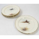 Six Royal Worcester plates, painted with different game birds in flight by Jas Stinton,