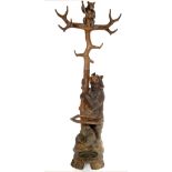 A Black Forest carved bear hall stand, the base carved with a naturalistic bear and cub,