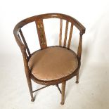 An Edwardian mahogany horseshoe shaped chair,