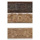 Three sections of carved oak, the larger section carved with a face and scrolls, length 30.