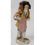 A 19th century Continental porcelain figure, of a street seller,